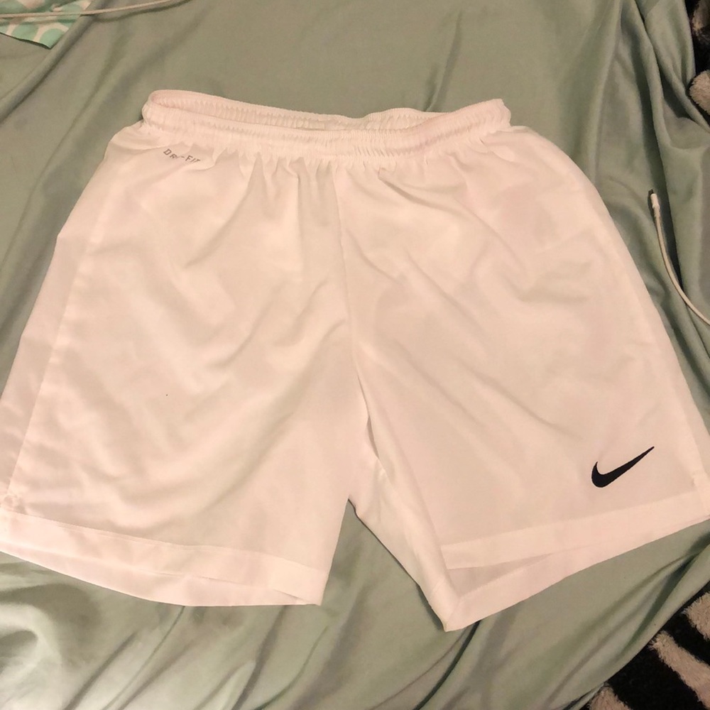White Nike woman’s dri-fit soccer shorts.